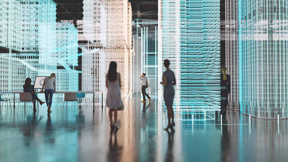 Engineers working in an empty industrial building with augmented reality software simulating a new city block.