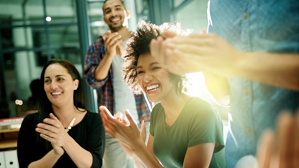 Shot of a team of creative businesspeople applauding an achievement