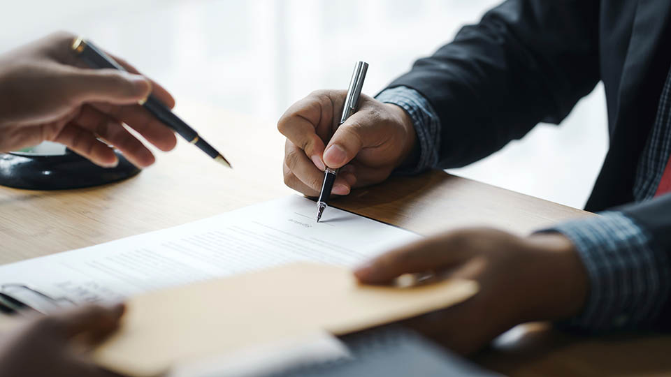 People signing a contract