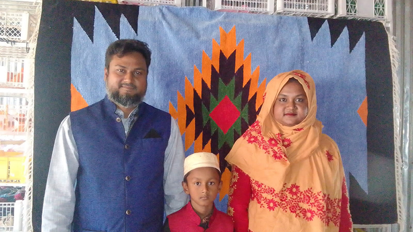 Mr. Zakiruzzaman, owner of a weaving micro enterprise with his wife and son