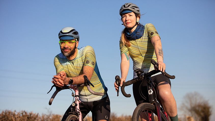 Man and woman cyclists on their bikes wearing Kostüme apparel in the outdoor