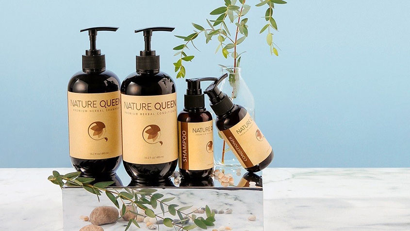 Four bottles of Thai Duong Nature Queen’s brand shampoo and hair conditioners on a mirror stand