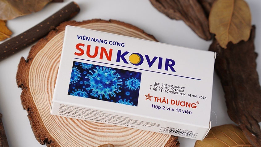 A box of Sunkovir tablets on a wooden slate and some wooden sticks and leaves