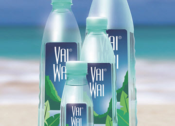 Four bottles of VaiWai® water in different sizes against a seaside backdrop