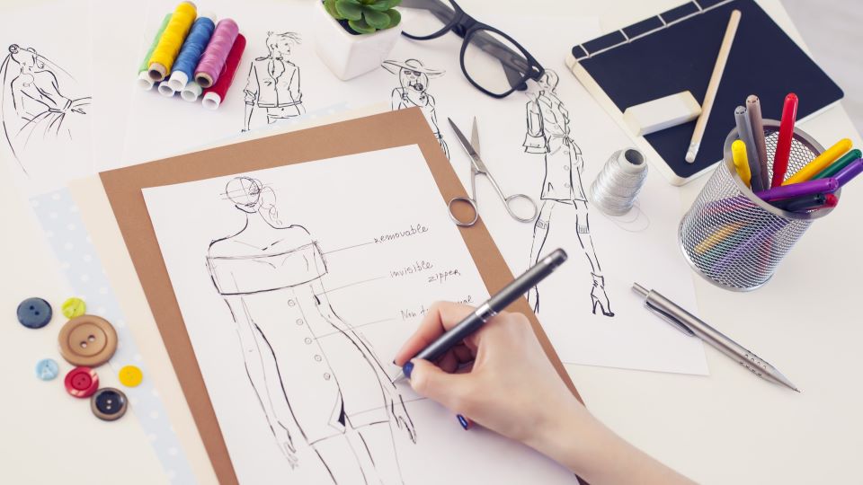 a fashion designer drawing a design of a garment