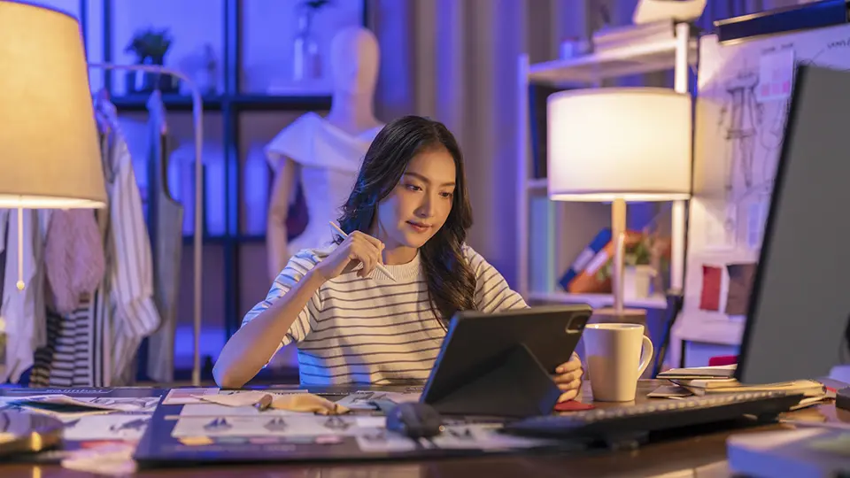 a female fashion designer working at her desk