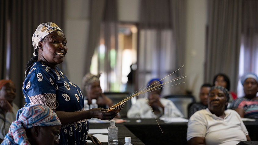 Photo of a master weaver explaining quality standards