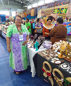 Vani Rokobeta at a Ba Women’s Forum fair, standing next to a stand displaying jewelry