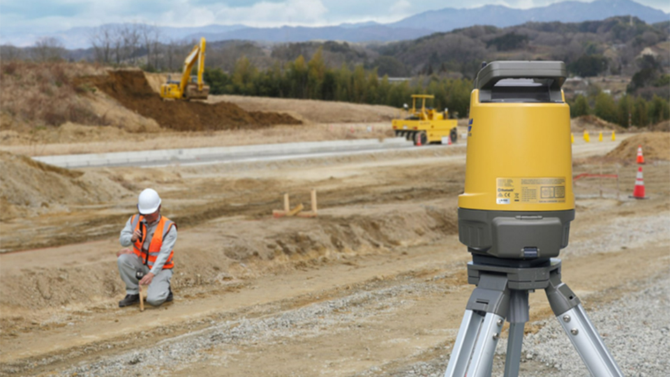 The Layout Navigator LN-100 land surveying device in use by a surveyor on a construction site to stakeout