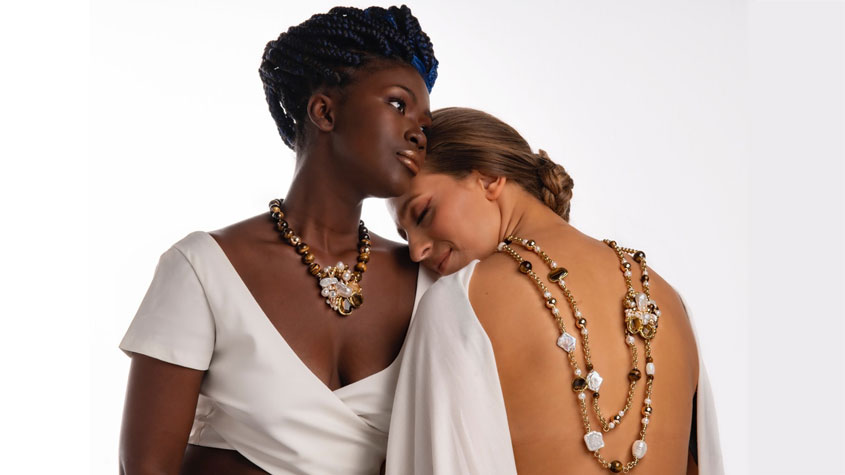Photo of two models wearing HABIBA’s ethnic necklaces from the Frida’s Lumières d’Orient collection, featuring Tiger’s eye gemstones.