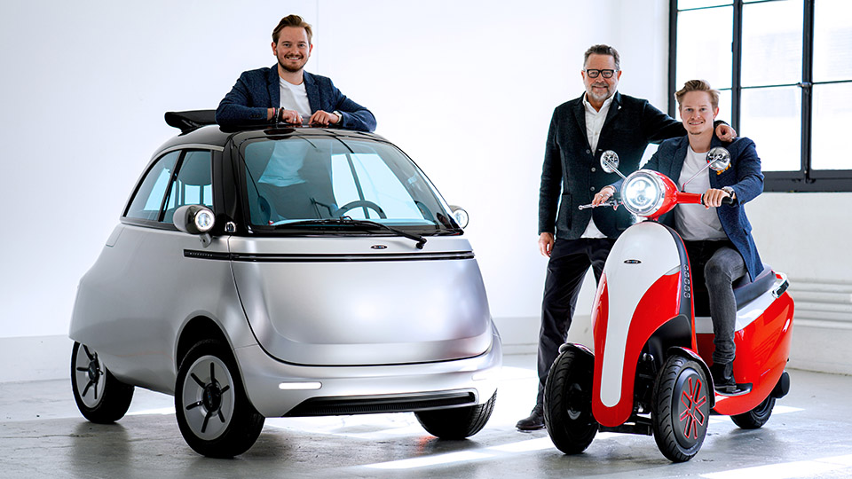 Wim Ouboter with his two sons sat in the Microlino Electric Bubble Car