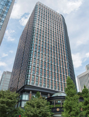 Photo of the Matsumoto glass tower block with trees in the foreground