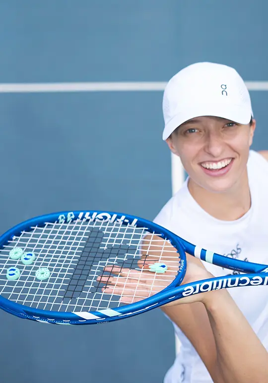 Female player with a blue Tecnifibre tennis racket