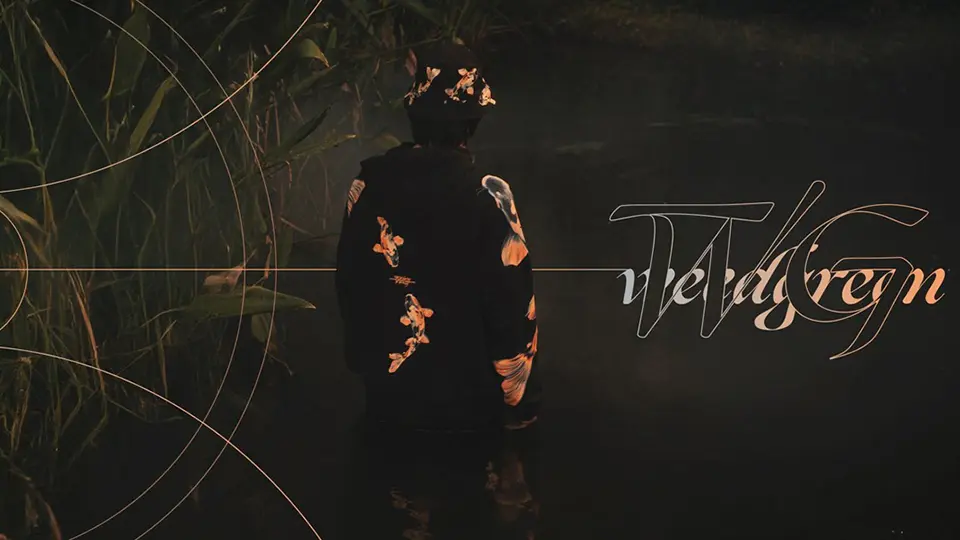 Man wearing Weedgreen Koi Art hoodie and bucket hat in Black