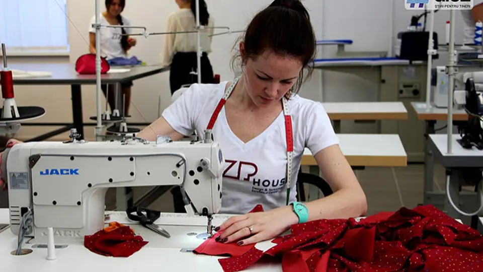 ZIPHOUSE tailor sewing red fabric at an industrial sewing machine