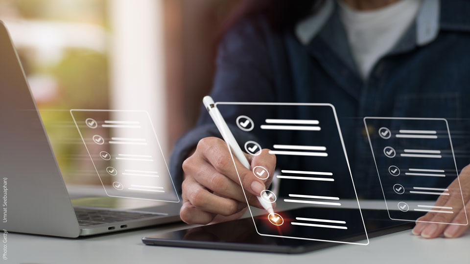 Visual shows a person using a stylus on a tablet beside a laptop, interacting with a digital checklist interface.