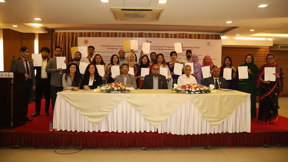 Group photo of participants holding certificates at an Intellectual Property awareness program ceremony in Bangladesh