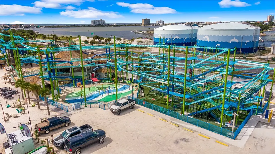 Large outdoor adventure course with elevated tracks and obstacles near the waterfront.