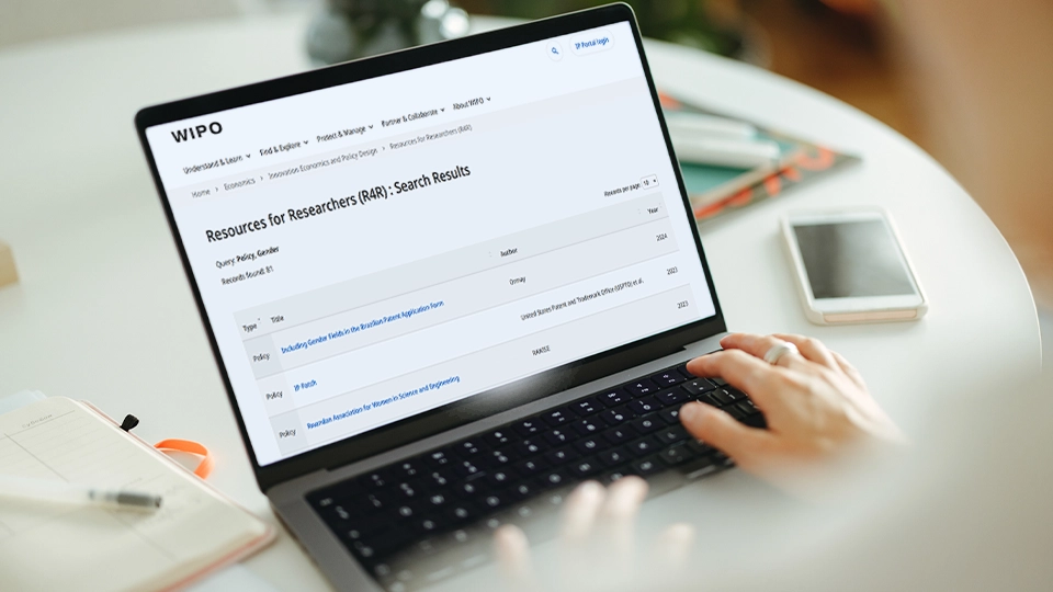 Woman going through database search results on laptop