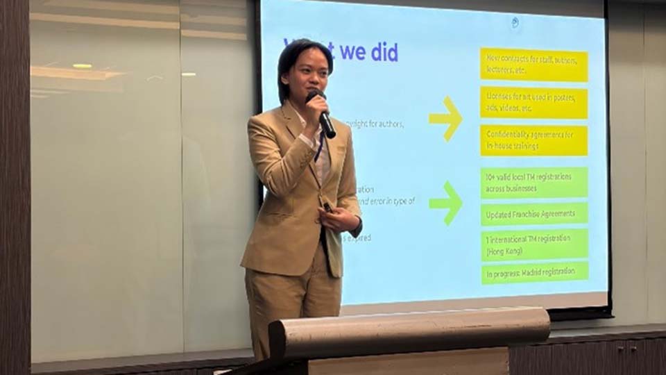 A speaker presents at an SMX podium with a slide titled "What we did," highlighting IP achievements including trademark registrations and franchise agreements.
