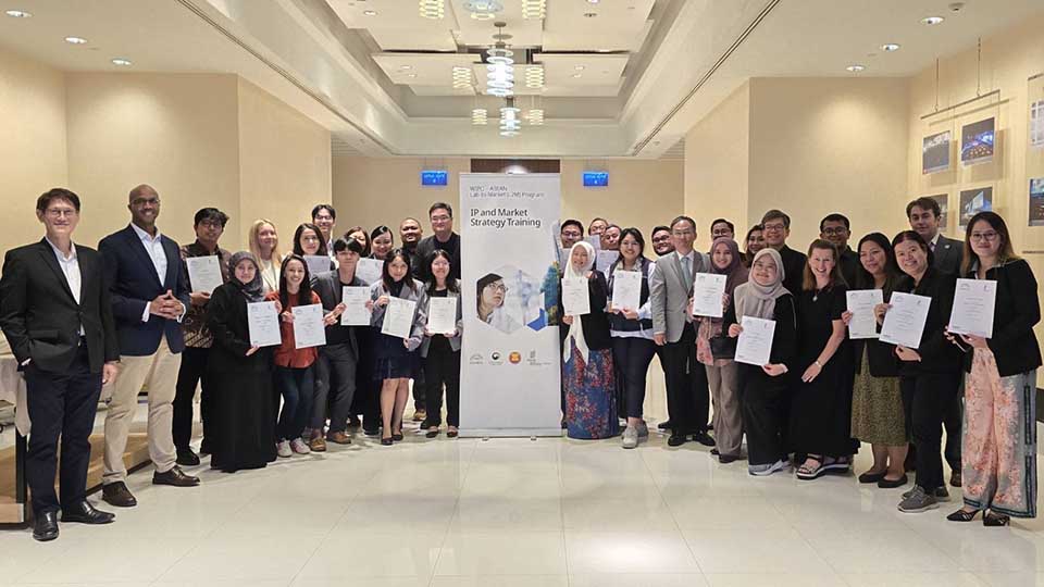 Small group of WIPO-ASEAN training participants posing with a trainer after the IP and Market Strategy Training session
