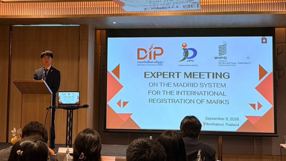 Man speaking at a podium, with a screen behind him reading Expert Meeting on the Madrid System for the International Registration of Marks, dated September 8, 2026, in Nonthaburi, Thailand, featuring DIP, JPO, and WIPO logos.