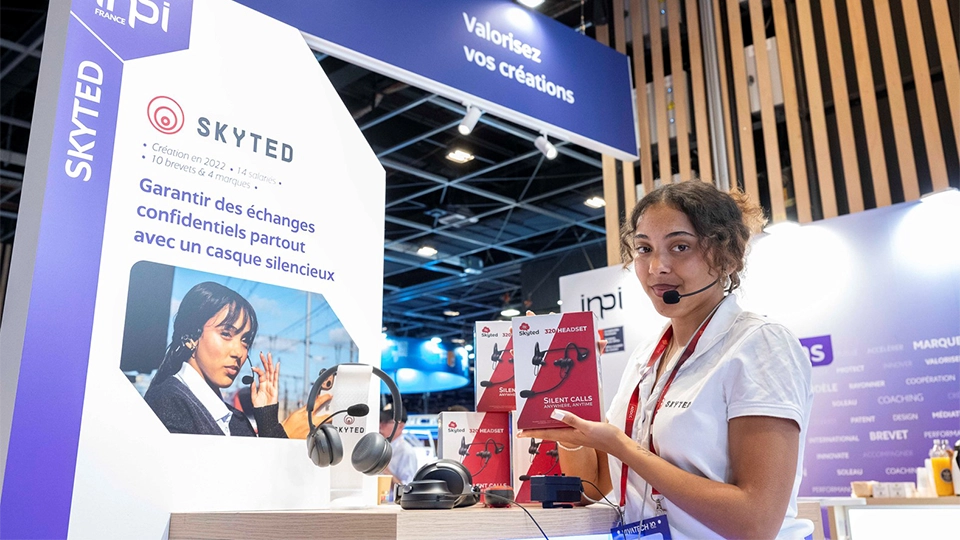 A Skyted team member presents the company's silent communication headset at VivaTech 2026, in Paris.