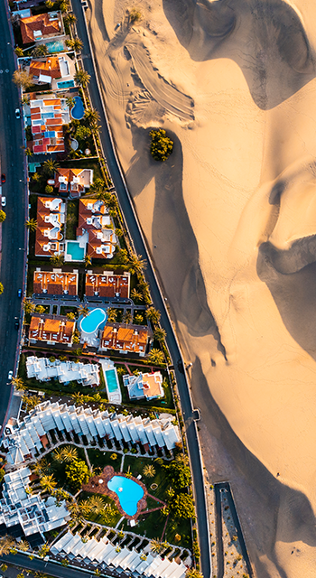 Overhead view of cityscape and sand dunes in Maspalomas, Grand Canary, Spain