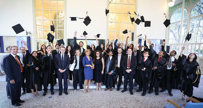 The graduating class of 2017 celebrating by throwing their hats in the air