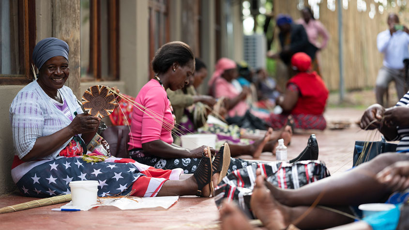 Photo of women basket weaving in a practical training session