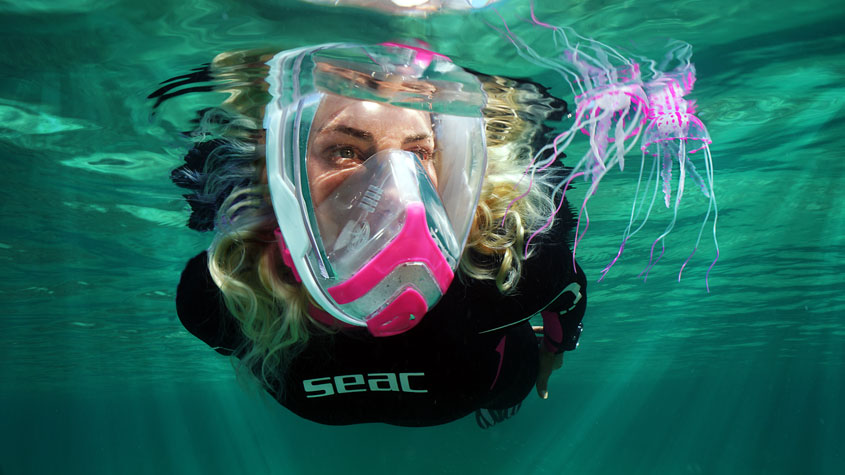 Photo of a swimmer wearing the Unica full-face snorkeling mask.