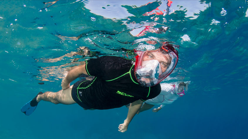Photo of a swimmer wearing the Unica full-face snorkeling mask