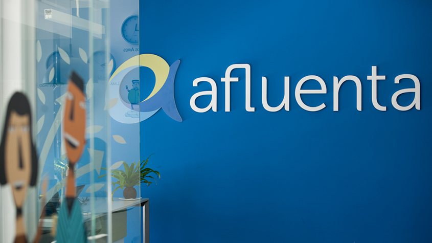 Afluenta’s name and logo on a blue wall in company’s office