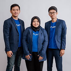 Indraka Fadhillah, Utari Octavianty, and Farid Naufal Aslam, the three co-founders of Aruna, standing, with dark jacket and blue Aruna tee-shirts