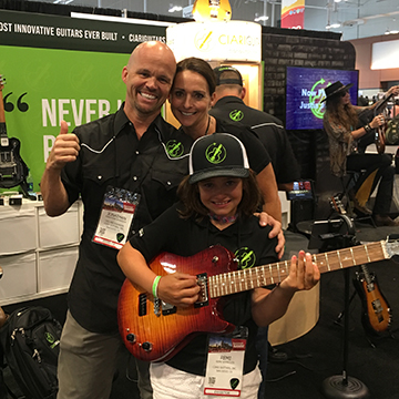 The Spangler Family, Jonathan, Trish and Remy (who is holding the Ascender Electric Guitar), exhibitors at the NAMM Show