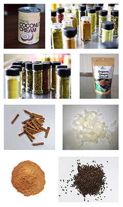 A range of JAPC products including a tin of organic coconut cream, bottled spices, a bag of organic ginger powder, sticks of cinnamon, coconut flakes, ground spices, and black pepper