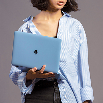 Young student holding a folded KOOMPI laptop