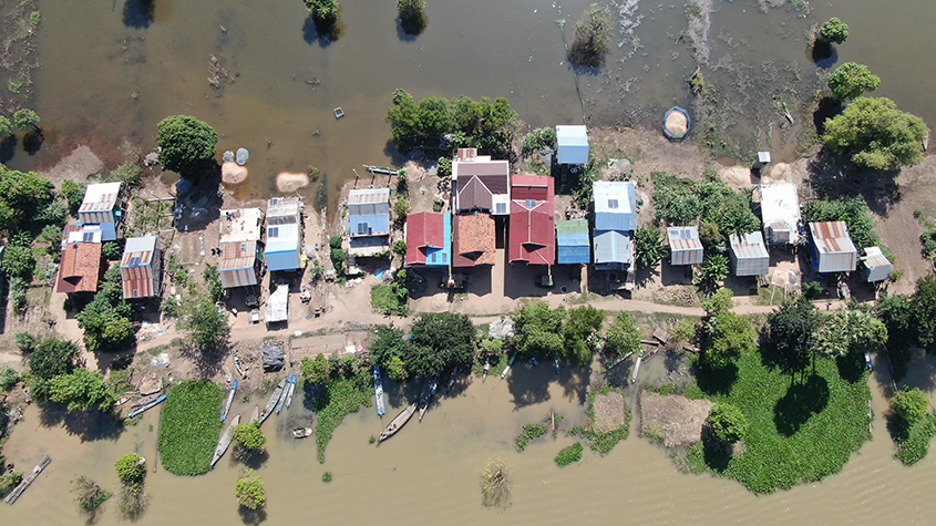 Drone view of a rural village in the Philippines with Okra Solar Mesh-Grids fitted on rooftops