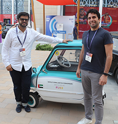 The FUSE team posing in front of a P50 car, the world’s smallest EV converted car