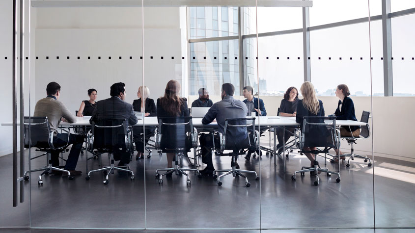 Photo of business people attending a meeting in a conference room