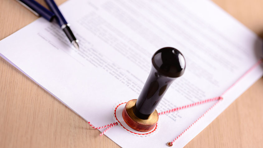 Notary's public pen and stamp on a legal document