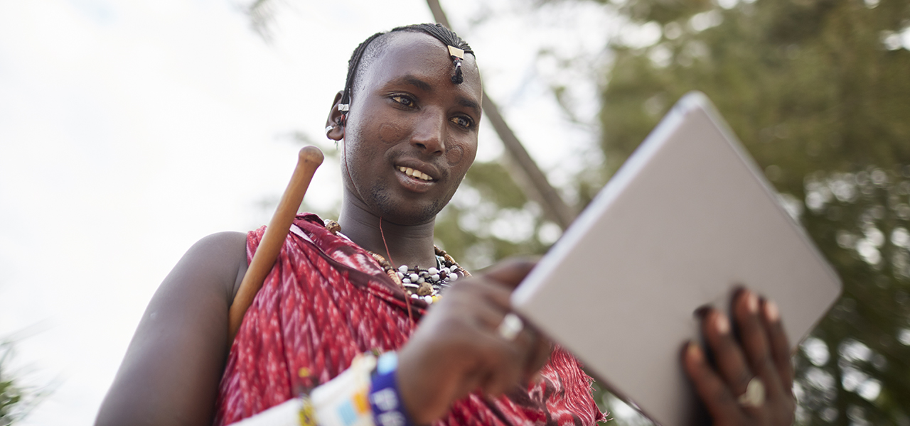 Maasai nomadic man using a tablet