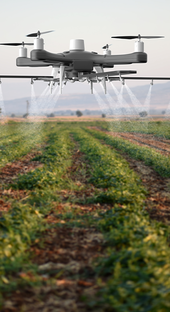Drone spraying a field - stock photo