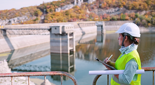 Working day on a hydroelectric power plant. Checking the condition of the power equipment, and analysing the data and the results of measurements with a mobile app.