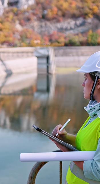 Working day on a hydroelectric power plant. Checking the condition of the power equipment, and analysing the data and the results of measurements with a mobile app.