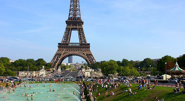 iew of paris - Tower Eiffel under a blue sky and people swimming in a pool during the hot and killing summer of 2004 in Europe