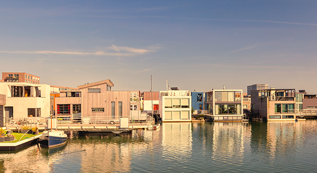 Row of contemporary house boats in the IJburg district during sunset in Amsterdam, The Netherlands