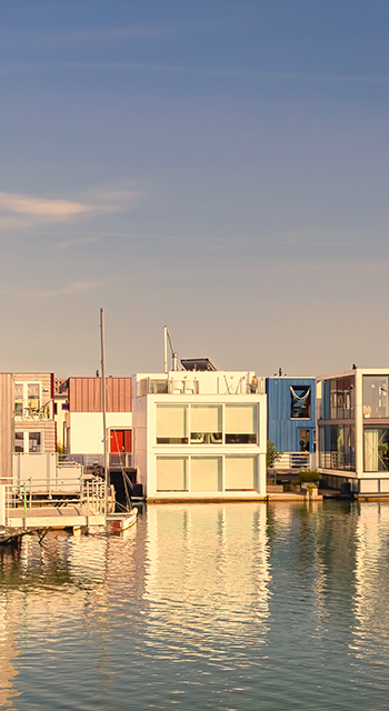Row of contemporary house boats in the IJburg district during sunset in Amsterdam, The Netherlands
