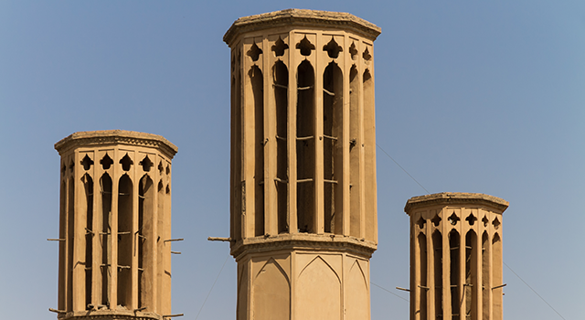 Rooftop Badgirs (windtowers) in the mud-brick desert city of Yazd, Iran. An ancient airconditioning system that captures the wind for cooling the houses below.