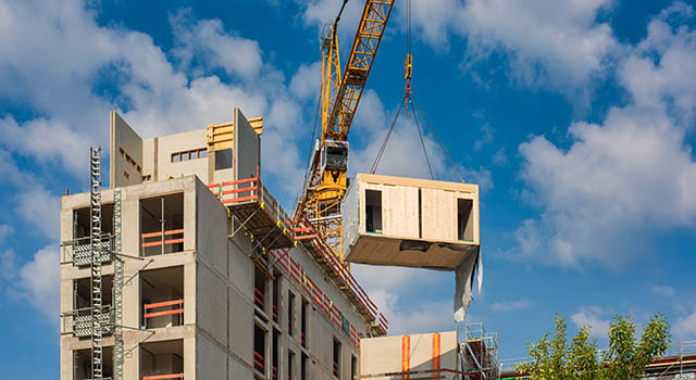 Construction site of an office building in Berlin. The new structure will be built in modular timber construction. MODULAR WOODEN HOUSES made out of renewable resources.